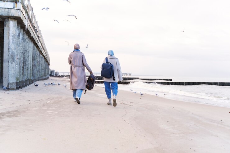 two-muslim-women-with-hijabs-taking-walk-beach-while-traveling_23-2149275818